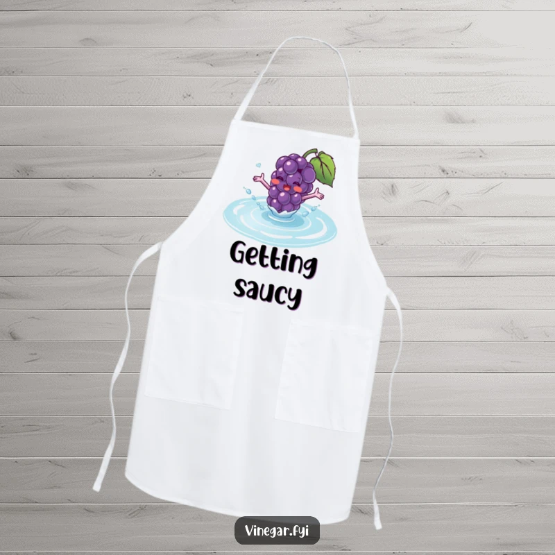 Funny apron showing a blushing purple grape with tiny arms excitedly splashing into a puddle of translucent fluid.