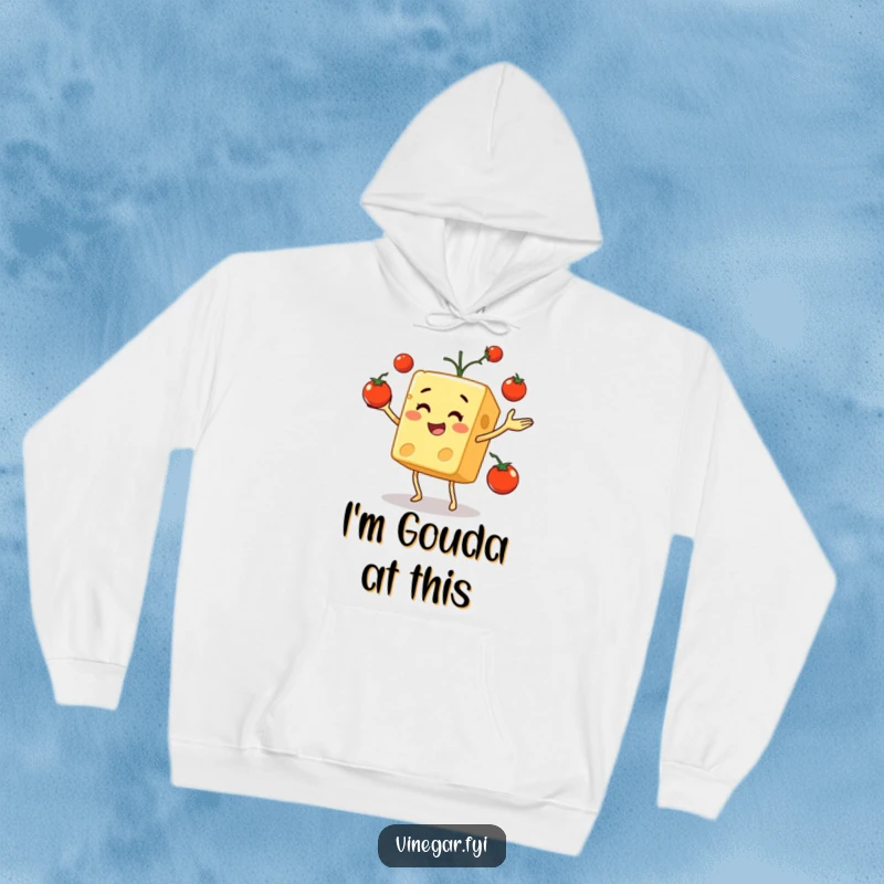 Funny hoodie depicting a happy cheese cube enthusiastically juggling a pile of vibrant cherry tomatoes, designed for ultimate comfort.