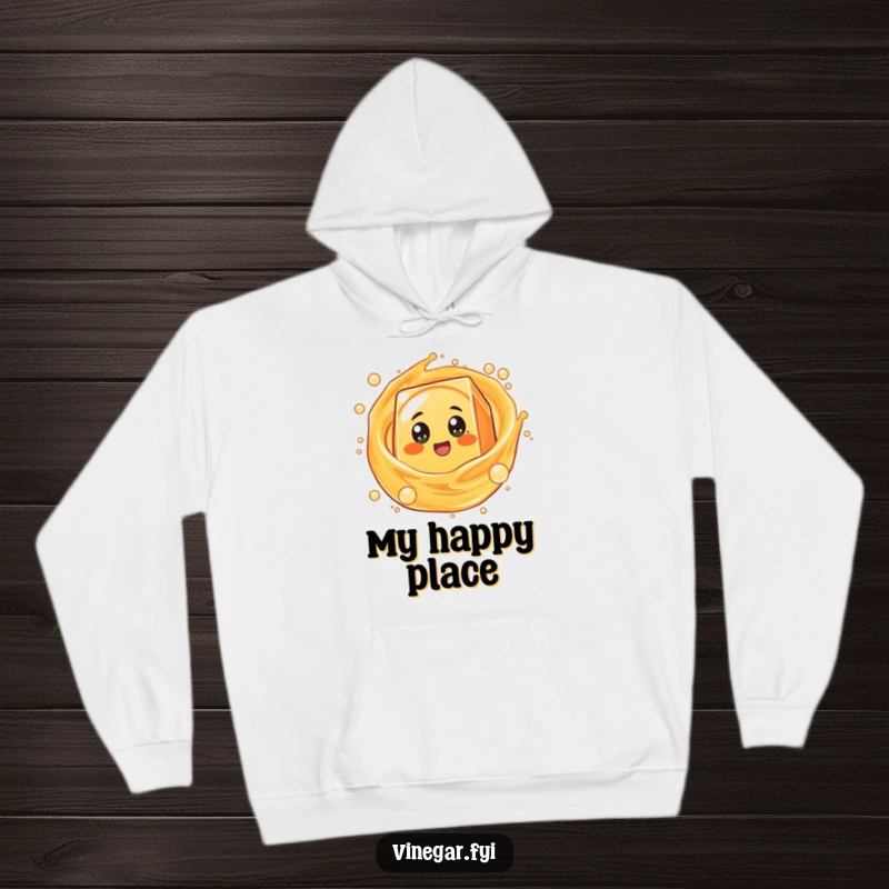 Funny round orange juice box character with excited eyes spinning in bubbly liquid, designed for comfort on a hoodie.